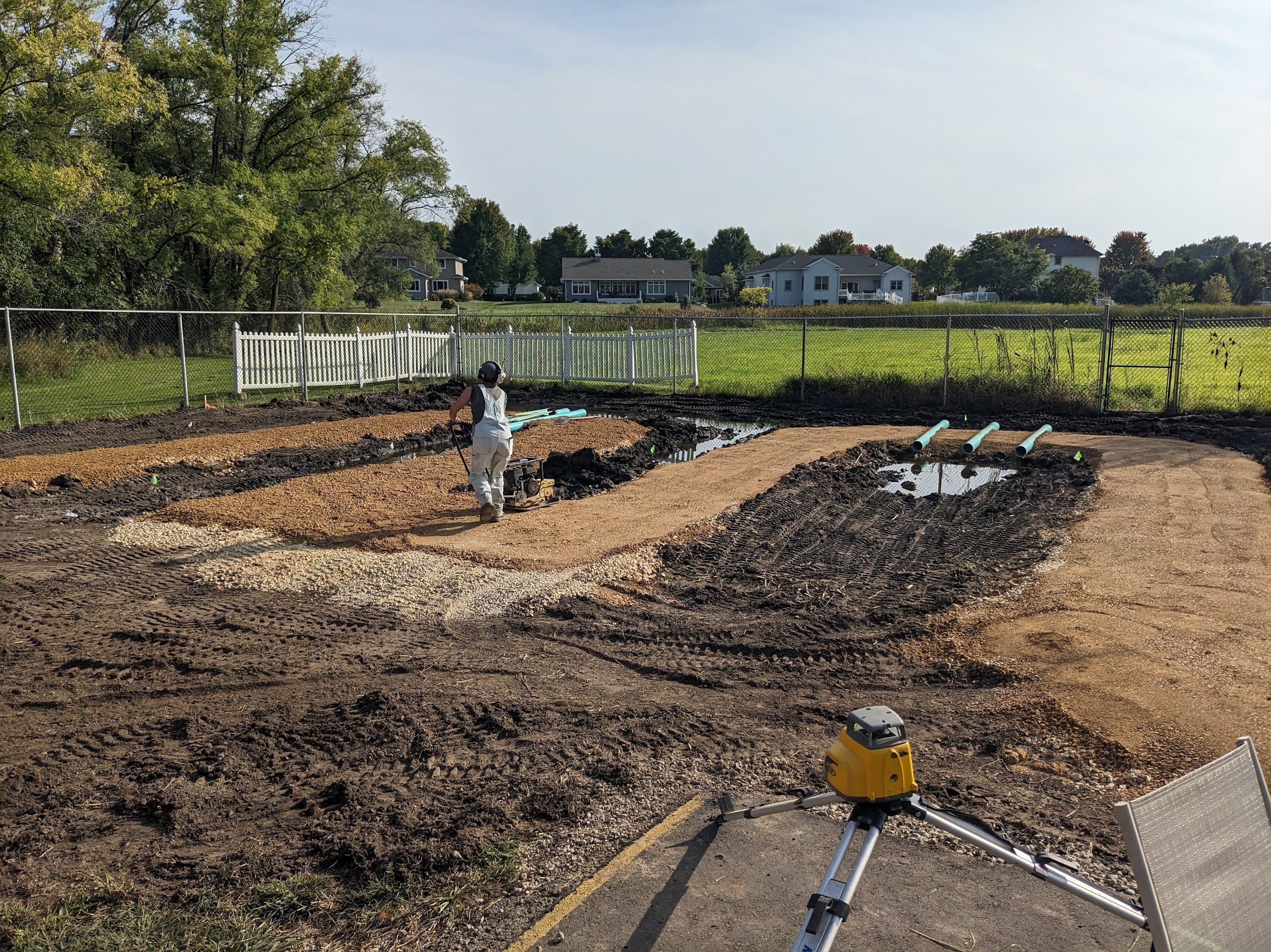 Coulee Region Ecoscapes digs swales and tamps walkway during construction